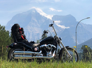 A photo of a Harley Davidson with a Rocky Mountain background